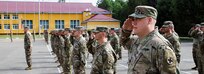 Soldiers with Task Force Illini, 33rd Infantry Brigade Combat Team, Illinois National Guard present arms during a transfer of authority ceremony where Task Force Illini assumed command of Joint Multinational Training Group-Ukraine at Collective Training Center –Yavoriv, Ukraine, July 30. (U.S. Army photo by Sgt. Gregory Glosser)