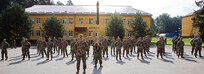 Soldiers with Task Force Illini, 33rd Infantry Brigade Combat Team, Illinois National Guard stand at parade rest during a transfer of authority ceremony where Task Force Illini assumed command of Joint Multinational Training Group-Ukraine at Collective Training Center –Yavoriv, Ukraine, July 30, 2020. (U.S. Army photo by Sgt. Gregory Glosser)