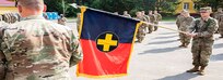 Task Force Illini, 33rd Infantry Brigade Combat Team, Illinois National Guard unfurrows its guidon signifying its assumption of command of Joint Multinational Training Group-Ukraine during a transfer of authority ceremony at Collective Training Center –Yavoriv, Ukraine, July 30, 2020. (U.S. Army photo by Sgt. Gregory Glosser)