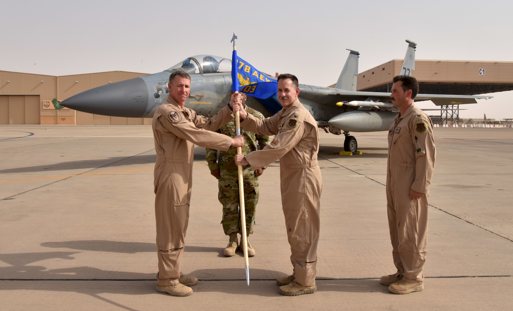 Col. Hurrelbrink, outgoing commander, relinquishes command of the 378th Expeditionary Operations Group to incoming commander, Col. Orgeron during the 378th EOG Change of Command Ceremony at Prince Sultan Air Base, Kingdom of Saudi Arabia.