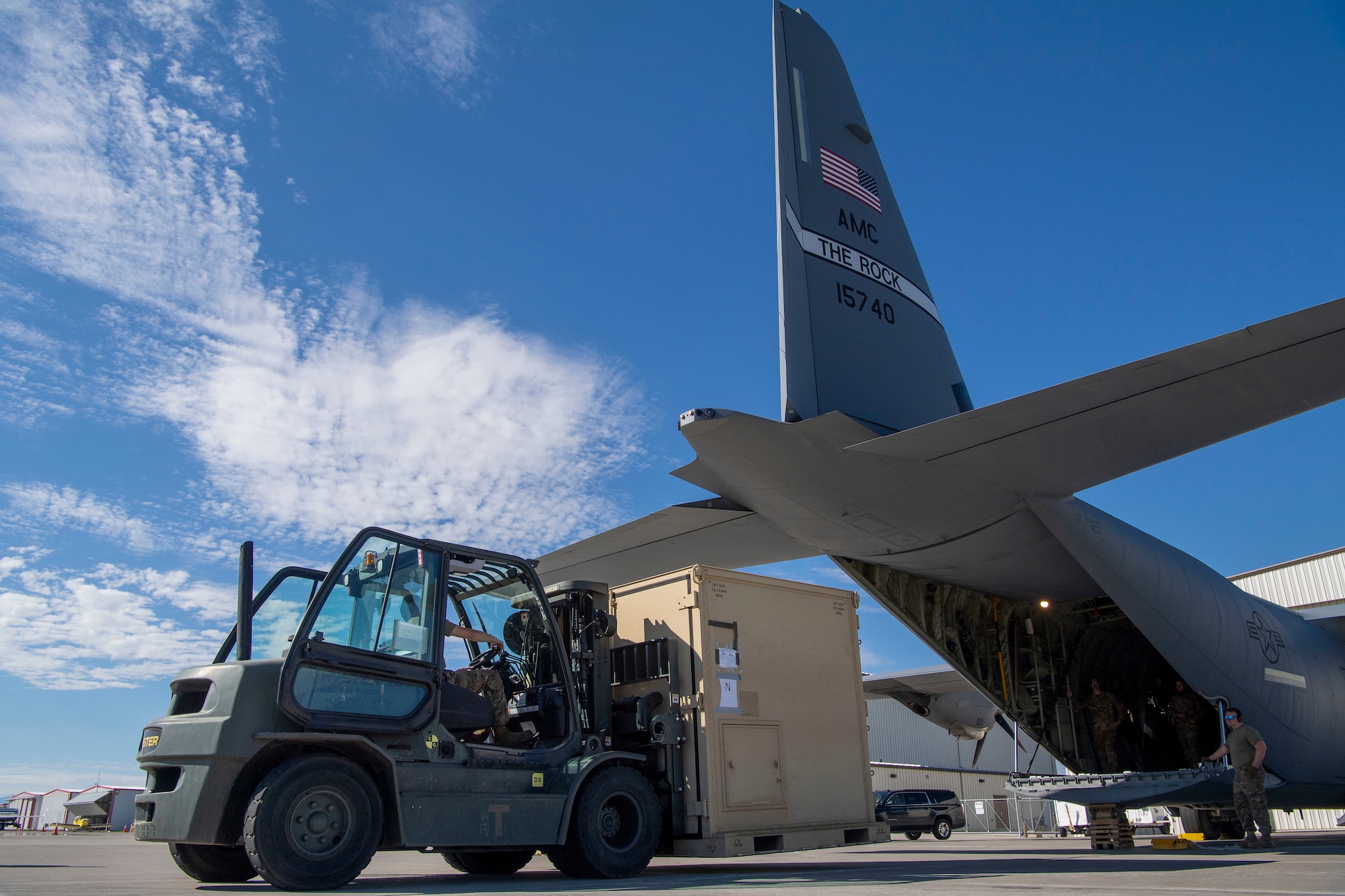 Airmen assigned to the 821st Contingency Response Squadron load cargo onto a C-130J Super Hercules during pre-deployment training at Guernsey Airport, Wyoming, July 27, 2020. This training is part of the 4/12 deployment initiative, which was developed in 2019 between airlift squadrons from Dyess Air Force Base, Texas and Little Rock AFB, allowing each squadron a full year of dwell time followed by a four-month rotation to their respective area of responsibility. (U.S. Air Force photo by Airman 1st Class Aaron Irvin)