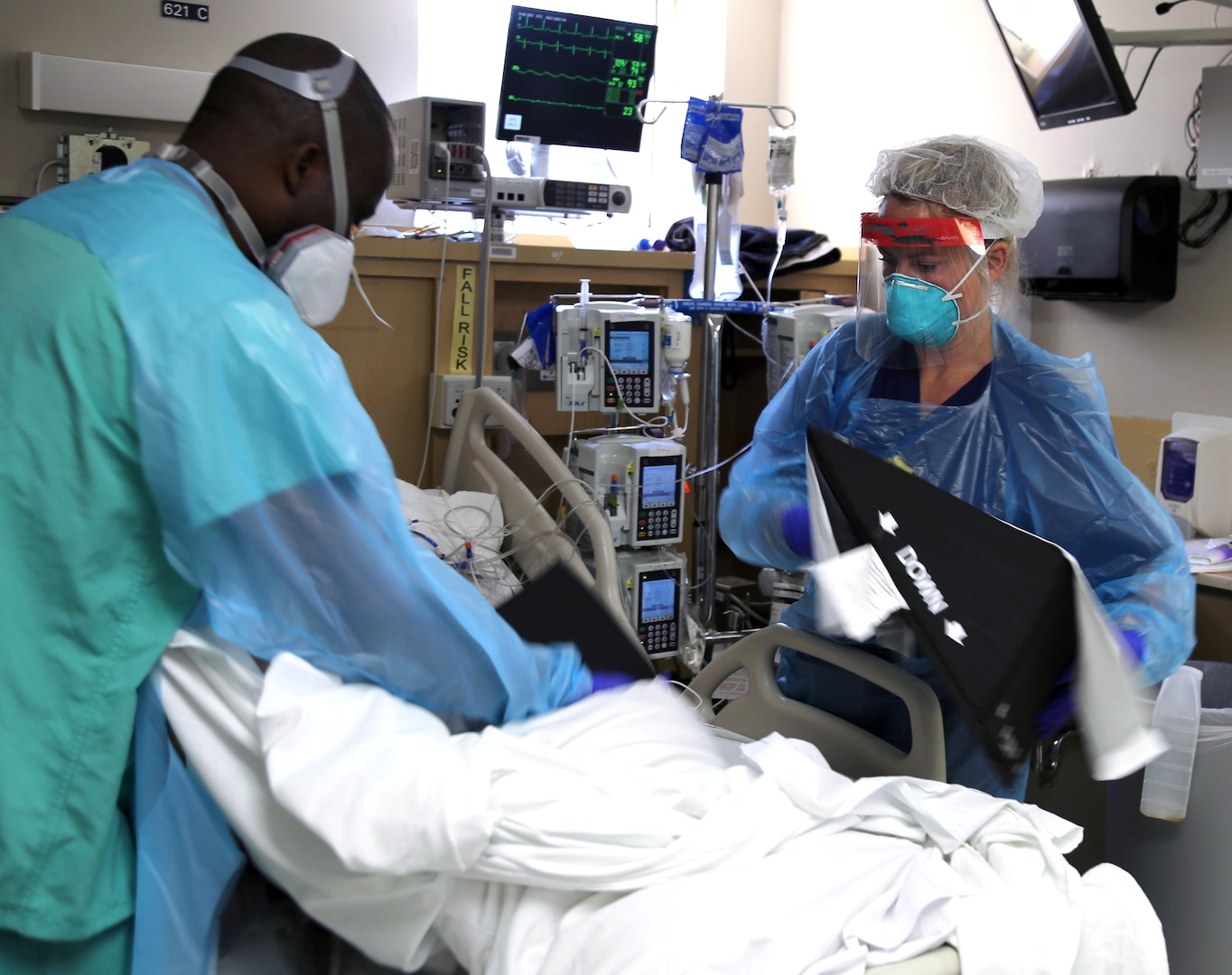 Capt. Stacey Johnson, critical care nurse from Urban Augmentation Medical Task Force-627, provides positioning aids to a COVID-19 patient, July 10, 2020 at Baptist Hospital in San Antonio, Texas.