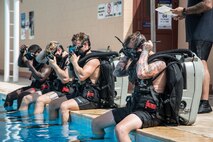 200723-A-FC661-1001 NAVAL SUPPORT ACTIVITY BAHRAIN (July 23, 2020) Explosive ordnance disposal technicians, assigned to Task Group (TG) 56.1, prepare to enter the pool onboard Naval Support Activity Bahrain as part of the virtual training presentations developed for Exercise Resolute Union 20, July 23, 2020. Resolute Union 20 is a part of a series of bilateral exercises between the Lebanese Armed Forces and U.S. Navy focused on explosive ordnance disposal and maritime security operations. (U.S. Army photo by Spc. Josh DuRant)