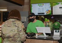 An Airman buys a smoothie.