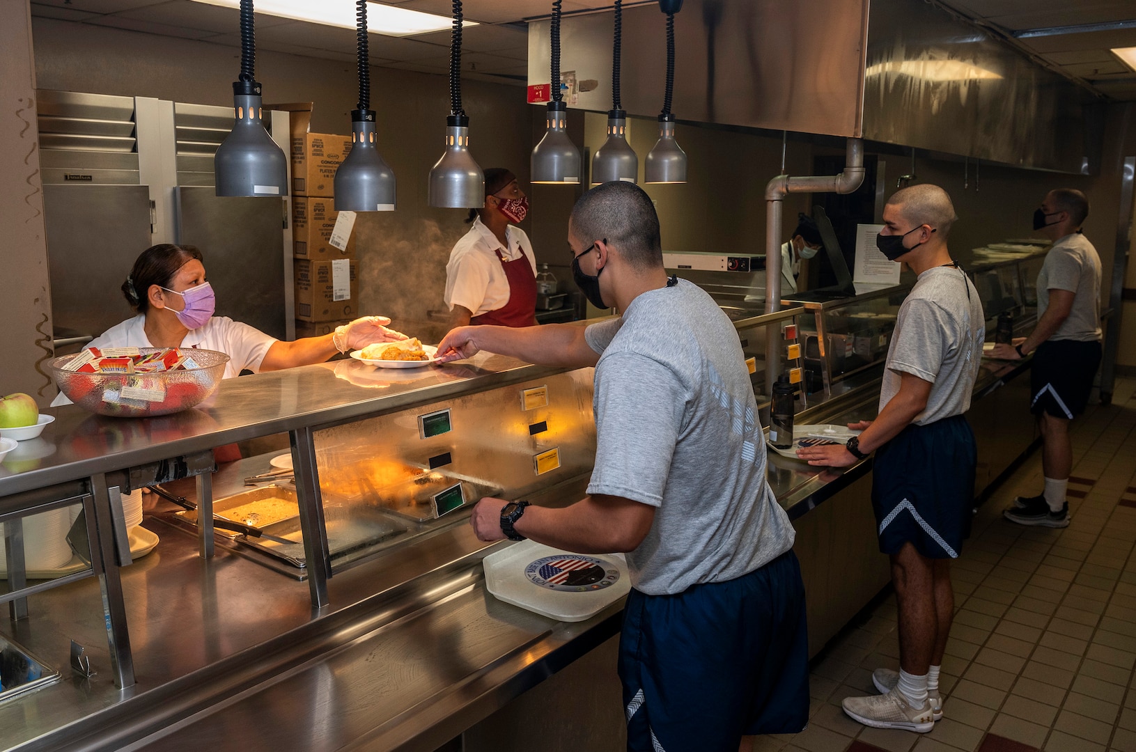 Air Force Basic Training Airmen receive meals in one of Joint Base San Antonio-Lackland's dining facilities May 21, 2020. The installation has the biggest food service contract in the Air Force.