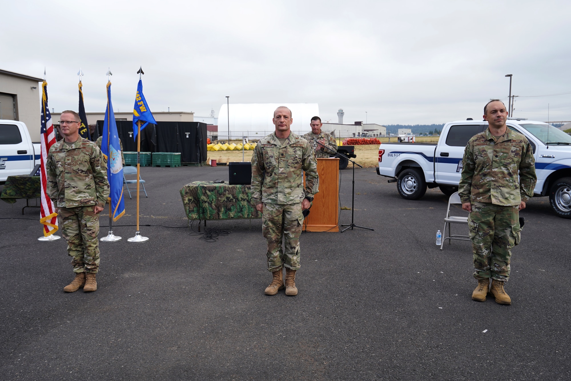 U.S. Air Force Lt. Col. Ryan Barton, center, assumes command of the 142nd Security Forces Squadron from Lt. Col. Caleb Westfall, right, during a change of command ceremony at the Portland Air National Guard Base, Ore., Aug. 2, 2020. Westfall retired directly after the change of command.