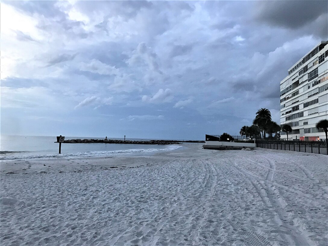 image of the sandy beach with a building at the right hand side