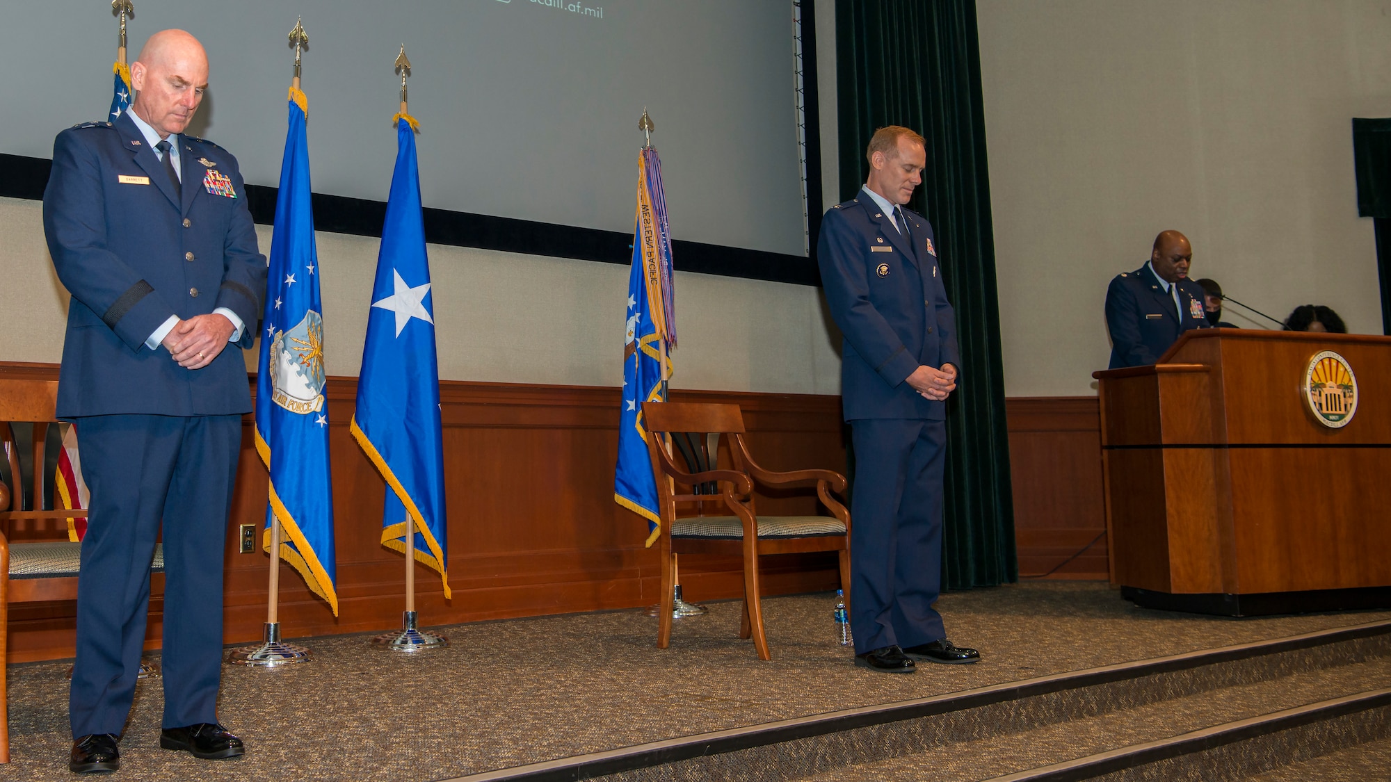 U.S. Air Force Maj. Gen. Sam Barrett, the 18th Air Force commander, and Col. Benjamin Jonsson, assuming 6th Air Refueling Wing (ARW) commander, bow their heads for an invocation by Lt. Col. Clyde Dyson, the 6 ARW chaplain, at MacDill Air Force Base, Fla., Aug. 4, 2020.