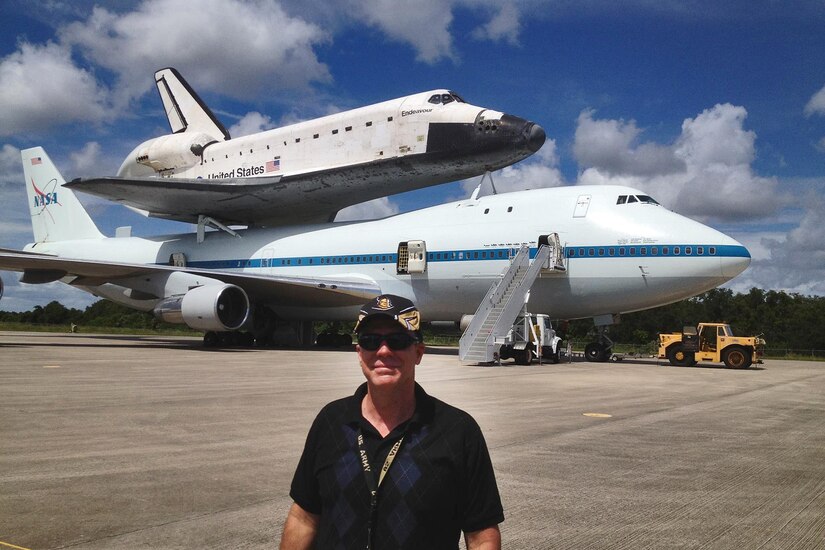 U.S. Army Reserve Lt. Col. Pat Lis stands in front of a Boeing 747-100 National Aeronautics and Space Administration Shuttle Carrier Aircraft that is carrying the Space Shuttle Endeavor at the Kennedy Space Center in Florida.