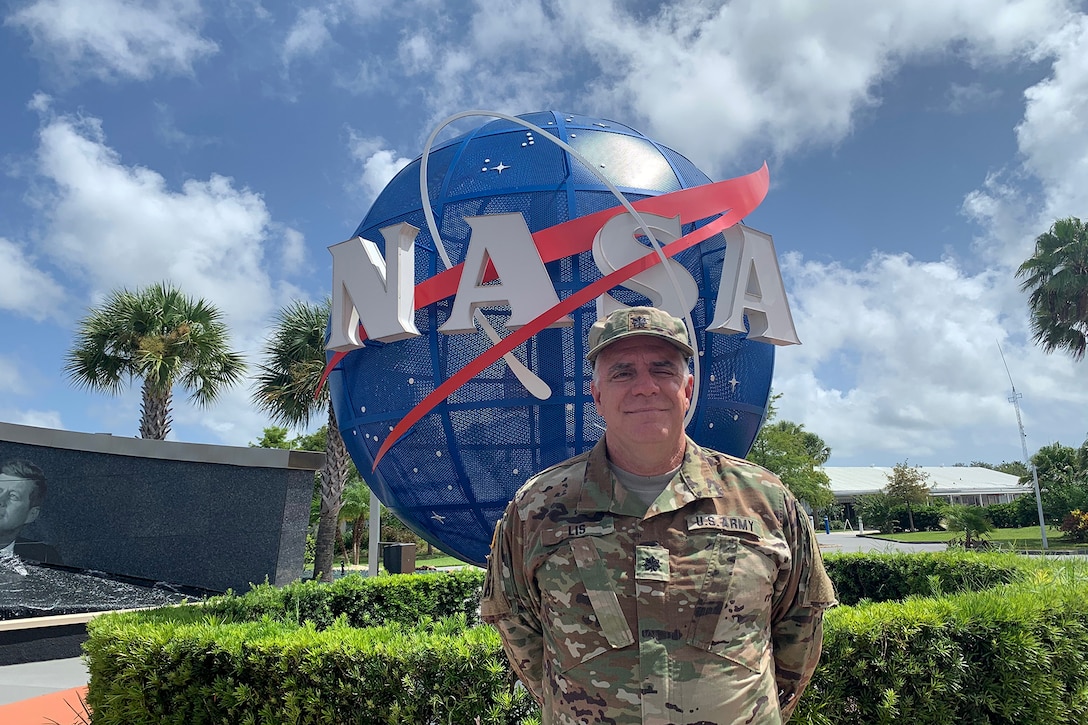 U.S. Army Reserve Lt. Col. Pat Lis pauses for a photo at the entrance to the Kennedy Space Center Visitor Complex in Florida.
