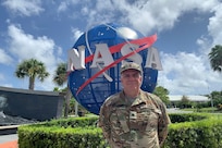 U.S. Army Reserve Lt. Col. Pat Lis pauses for a photo at the entrance to the Kennedy Space Center Visitor Complex in Florida.