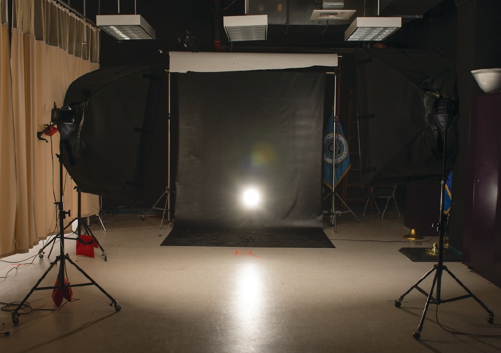 The back light that outlines the subject against the background in a studio setting.