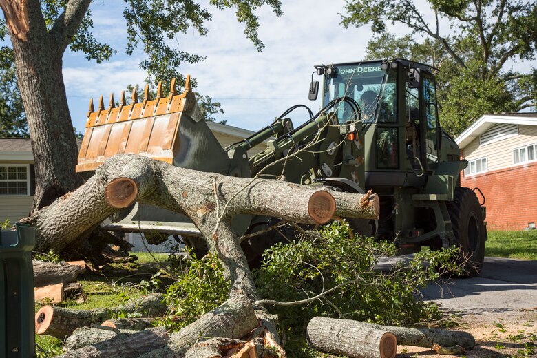 U.S. Marine Corps Lance Cpl. Anderson Rojas, with 8th Engineer Support Battalion, 2nd Marine Logistics Group, clears debris at Berkley Manor on Marine Corps Base Camp Lejeune, North Carolina, Aug. 4, 2020. U.S. Marines carried out recovery efforts after Hurricane Isaias in order to resume normal operations while following COVID-19 mitigation guidelines. (U.S. Marine Corps Photo by Lance Cpl. Isaiah Gomez)