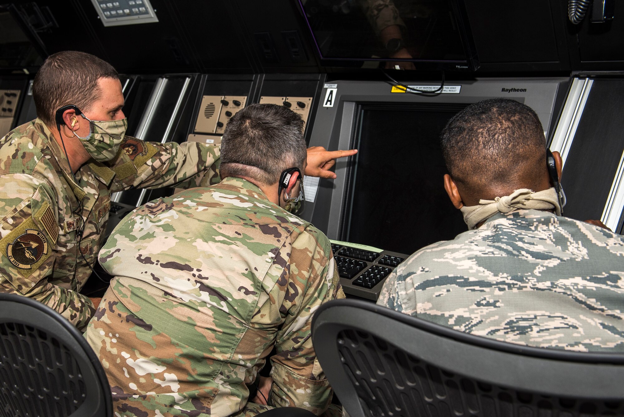 Members of the 27th Special Operations Support Squadron radar approach control team check the radar screen for potential weather at Cannon Air Force Base, N.M., July 23, 2020. The RAPCON is a facility that provides guidance and communication in the air space from 2,600 feet above ground level up to an altitude of 17,000 feet in the air. (U.S. Air Force photo by Senior Airman Vernon R. Walter III)