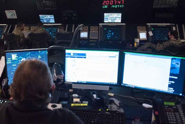 The chief controller of the 27th Special Operations Support Squadron radar approach control facility watches as their team keeps an eye on the air space they control at Cannon Air Force Base, N.M., July 23, 2020. The chief control provides overwatch to ensure all Airmen have support during high-traffic hours. (U.S. Air Force photo by Senior Airman Vernon R. Walter III)