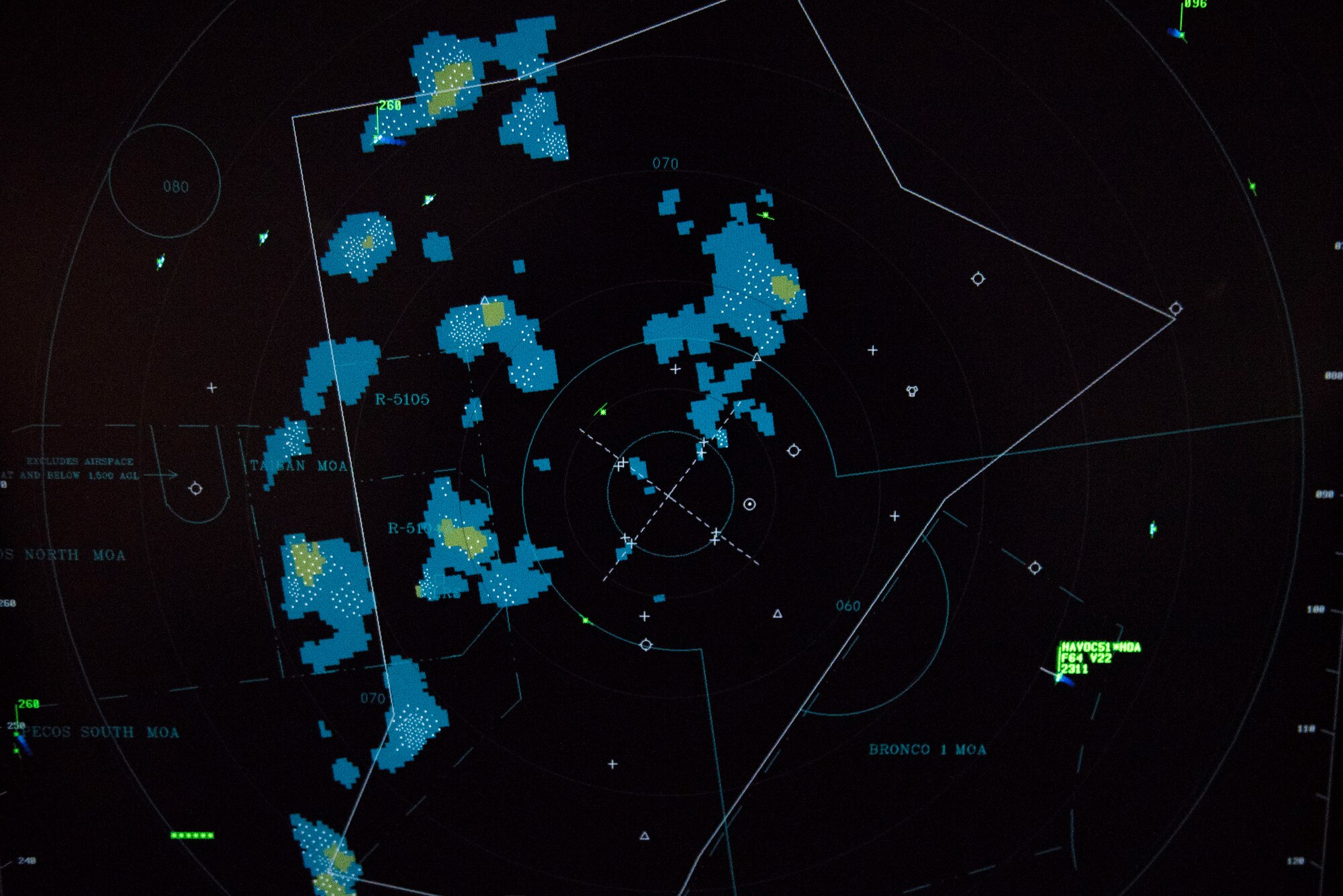 A radar screen of the area surrounding Cannon Air Force Base, N.M., shows weather patterns and aircraft to provide the information the 27th Special Operations Support Squadron radar approach control team needs to perform their mission July 23, 2020. The radar shows a wide radius so that the team can prepare for whatever enters their air space. (U.S. Air Force photo by Senior Airman Vernon R. Walter III)