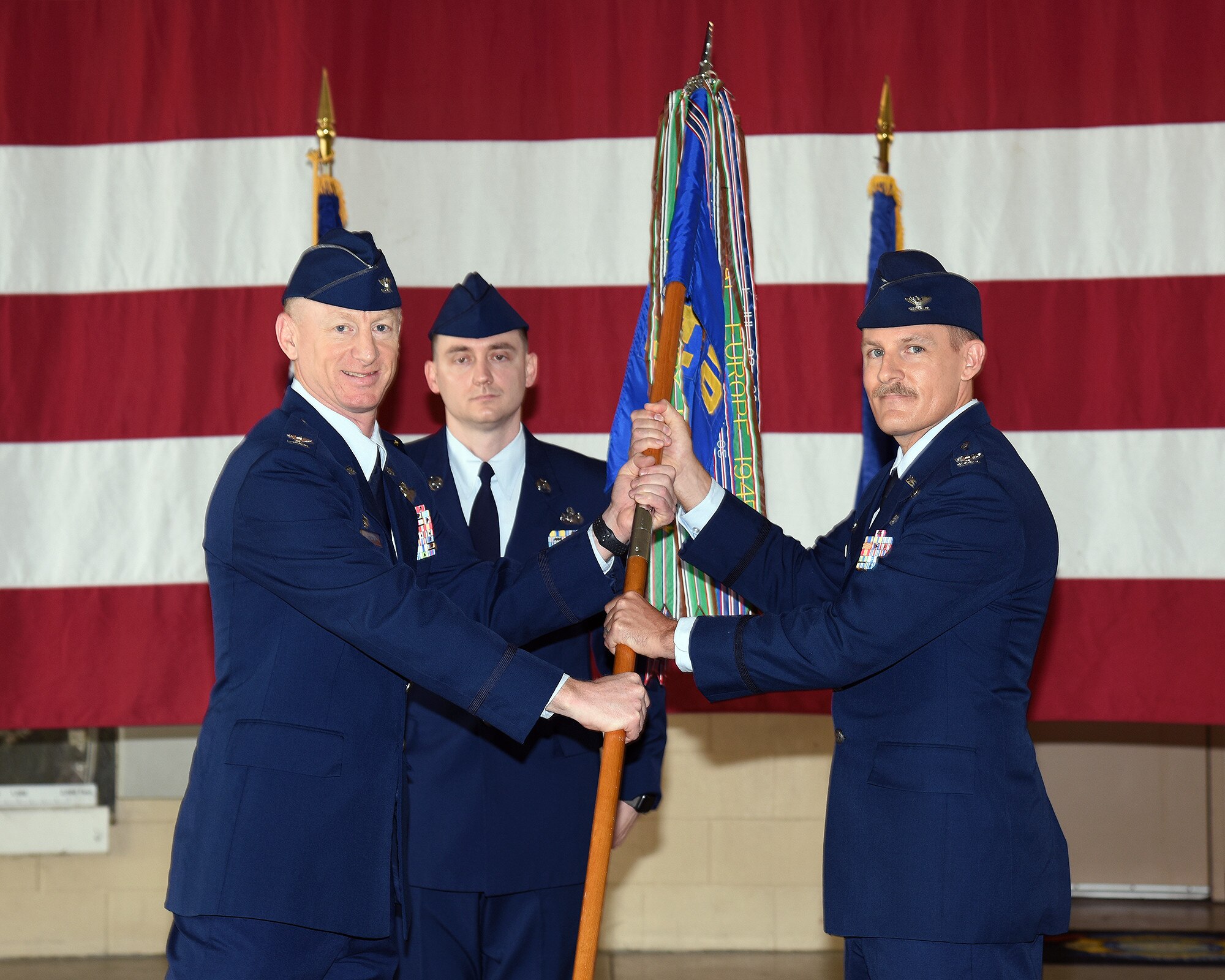 Col. Seth Graham, 14th Flying Training Wing commander, hands Col. Justin Spears, 14th Operations Group commander, the 14th OG guidon at the 14th OG change of command ceremony on July 24, 2020, at Columbus Air Force Base, Miss. The 14th Operations Group and its six squadrons are responsible for the 52-week Specialized Undergraduate Pilot Training (SUPT) mission at Columbus. The group also performs quality assurance for contract aircraft maintenance. (U.S. Air Force photo by Elizabeth Owens)