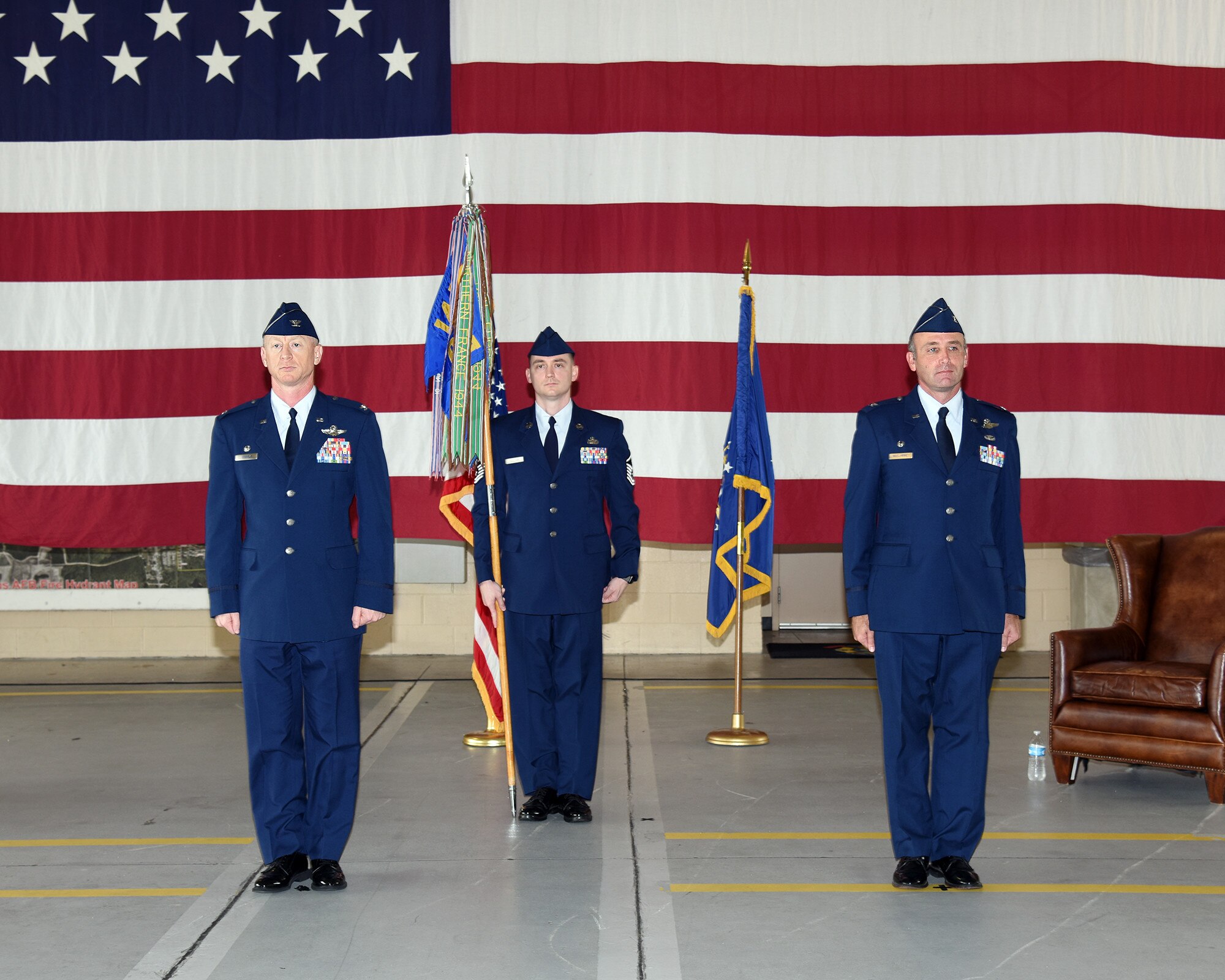 Col. Seth Graham, 14th Flying Training Wing commander, and Col. McElhinney III, former 14th Operations Group commander, stand at attention during the 14th OG change of command ceremony on July 24, 2020, at Columbus Air Force Base, Miss. The 14th Operations Group and its six squadrons are responsible for the 52-week Specialized Undergraduate Pilot Training (SUPT) mission at Columbus. The group also performs quality assurance for contract aircraft maintenance (U.S. Air Force photo by Elizabeth Owens)