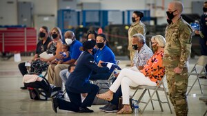 Senior Airman Timo Timoteo's father, Ioane, is presented with a folded U.S. flag in honor of his son's memory during a 412th Security Forces Squadron memorial ceremony at Edwards Air Force Base, Aug. 3. (Air Force photo by Giancarlo Casem)