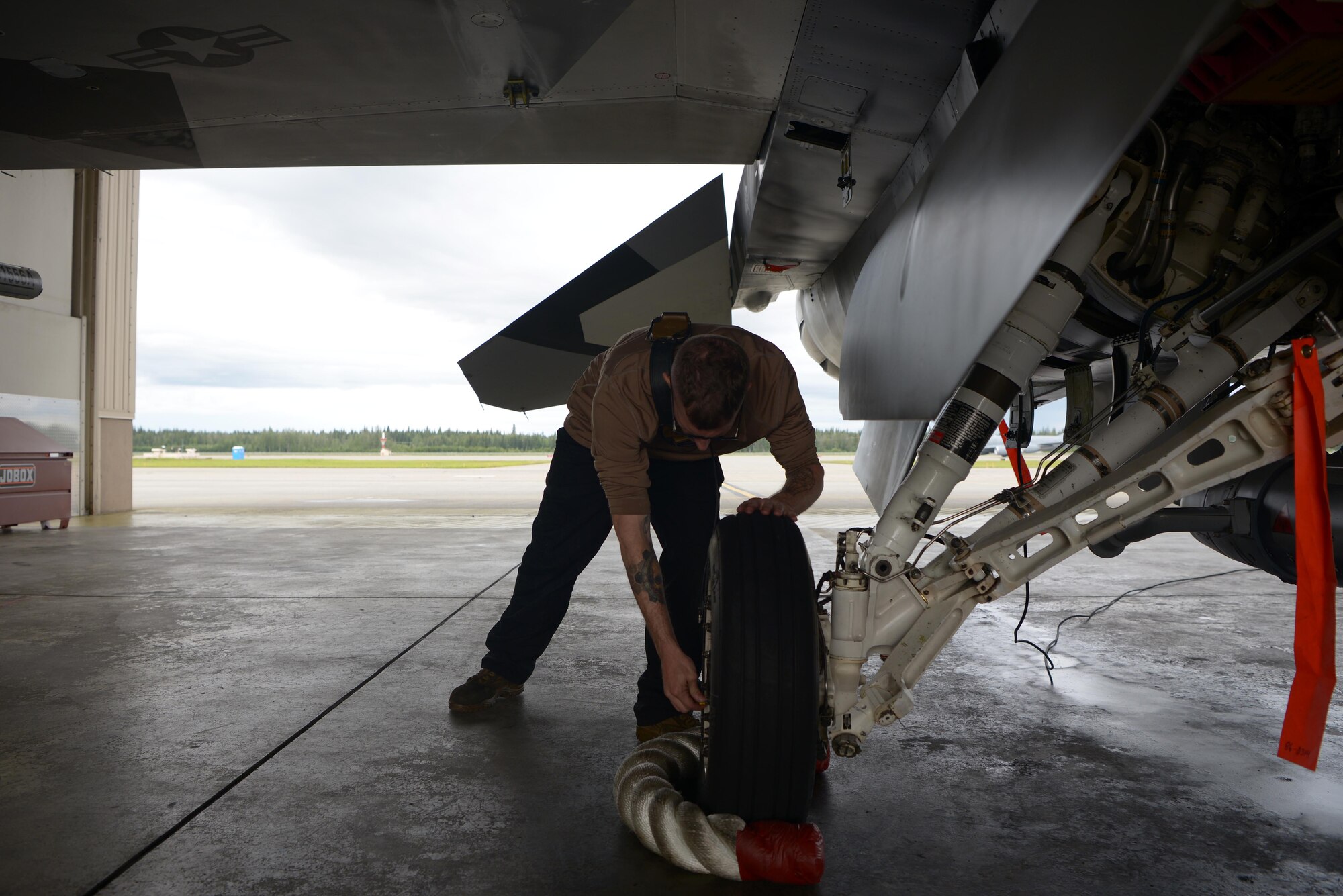 U.S. Air Force Senior Airman Joshua Zacharko, an 18th Aircraft Maintenance Unit (AMU) crew chief, inspects landing gear on an F-16 Fighting Falcon aircraft during RED FLAG-Alaska 20-3 on Eielson Air Force Base, Alaska, Aug. 4, 2020. The 18th AMU provides mission-ready maintainers to support the wing's aggressor missions and exercises throughout the Indo-Pacific region. (U.S. Air Force photo by Senior Airman Beaux Hebert)