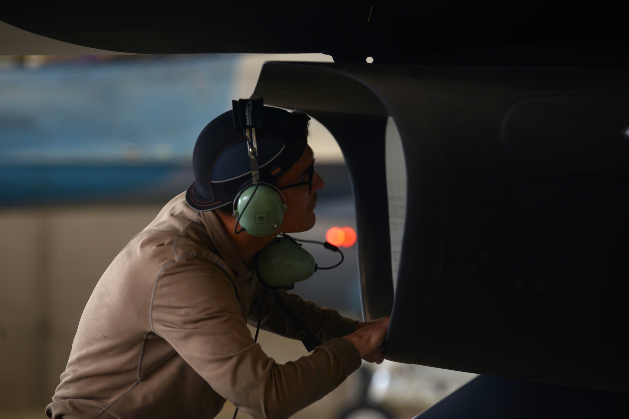 U.S. Air Force Airman 1st Class Jacob Camacho, an 18th Aircraft Maintenance Unit (AMU) crew chief, inspects an F-16 Fighting Falcon air intake during RED FLAG-Alaska 20-3 on Eielson Air Force Base, Alaska, Aug. 4, 2020. Prior to starting up the jet, crew chiefs look for debris that could potentially create a safety hazard. (U.S. Air Force photo by Senior Airman Beaux Hebert)