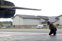 U.S. Air Force Airman 1st Class Jacob Camacho, an 18th Aircraft Maintenance Unit (AMU) crew chief, inspects the back of an F-16 Fighting Falcon aircraft during RED FLAG-Alaska 20-3 on Eielson Air Force Base, Alaska, Aug. 4, 2020. The 18th AMU provides aircraft and munitions maintenance support to the 354th Fighter Wing's aggressor aircraft operating at Eielson AFB.  (U.S. Air Force photo by Senior Airman Beaux Hebert)