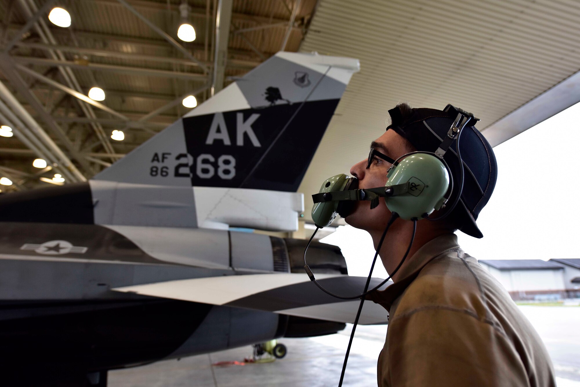 U.S. Air Force Airman 1st Class Jacob Camacho, an 18th Aircraft Maintenance Unit (AMU) crew chief, conducts preflight checks on an F-16 Fighting Falcon aircraft during RED FLAG-Alaska 20-3 on Eielson Air Force Base, Alaska, Aug. 4, 2020. The 354th Maintenance Group provides aircraft and munitions maintenance support to the 354th Fighter Wing's F-35 Lightning II fifth-generation aircraft, F-16 Fighting Falcon aggressor aircraft, RED FLAG-Alaska, tanker task force, transient and special mission aircraft operating at Eielson AFB. (U.S. Air Force photo by Senior Airman Beaux Hebert)