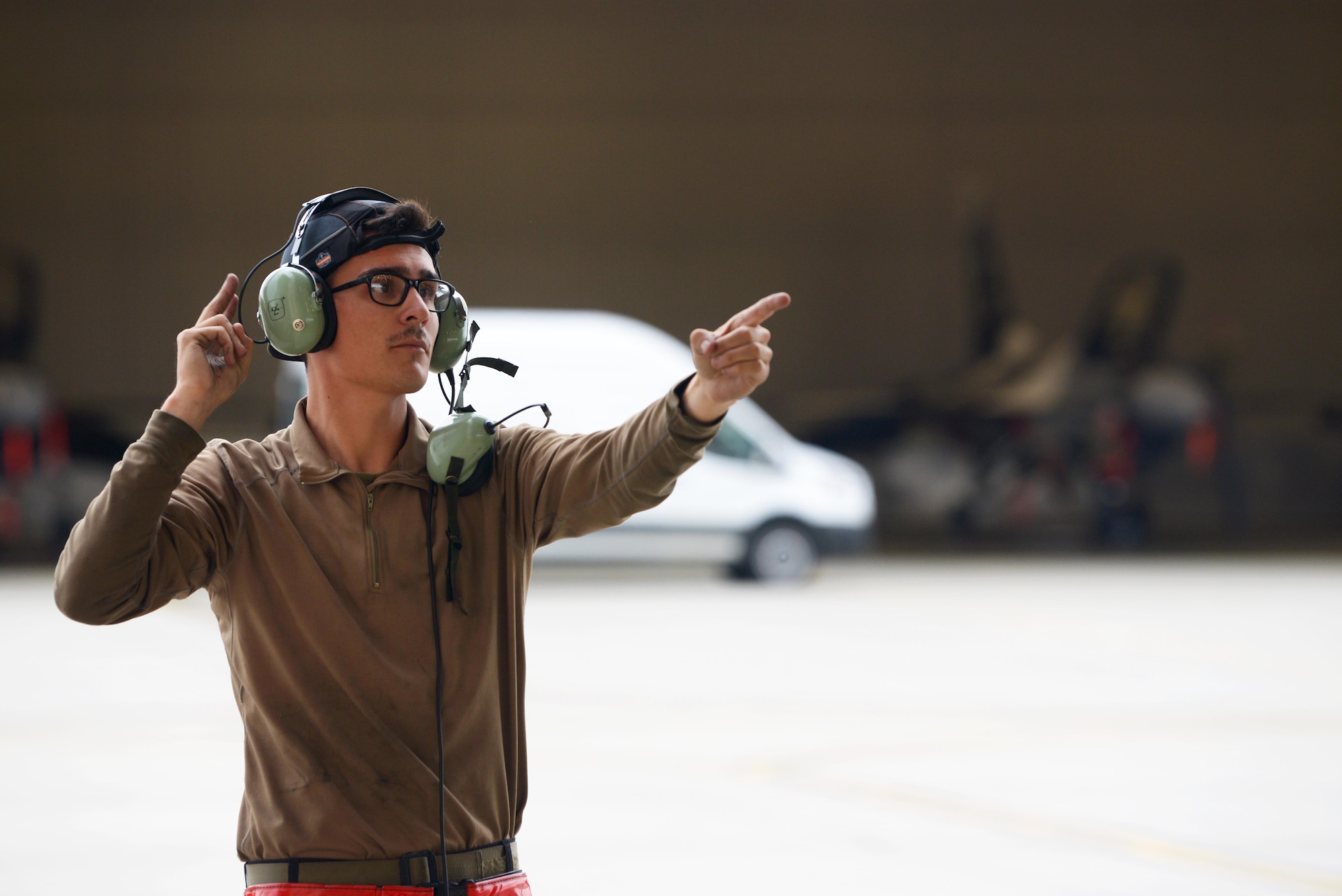 U.S. Air Force Airman 1st Class Jacob Camacho, an 18th Aircraft Maintenance Unit (AMU) F-16 Fighting Falcon crew chief, marshals an aircraft during RED FLAG-Alaska 20-3 on Eielson Air Force Base, Alaska, Aug. 4, 2020. After all preflight checks are complete, crew chiefs direct the aircraft from its parking spot and render a final salute to the pilot to complete their checklist. (U.S. Air Force photo by Senior Airman Beaux Hebert)