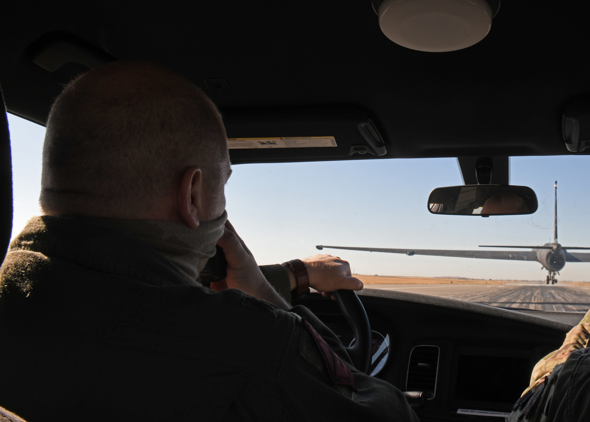 Maj. Nathanael Tolle, 1st Reconnaissance Squadron U-2 pilot, assists a U-2 pilot in a chase car July 31, 2020 at Beale Air Force Base, California. A chase car driver provides U-2 pilots critical information like altitude and runway alignment. (U.S. Air Force photo by Airman 1st Class Luis A. Ruiz-Vazquez)