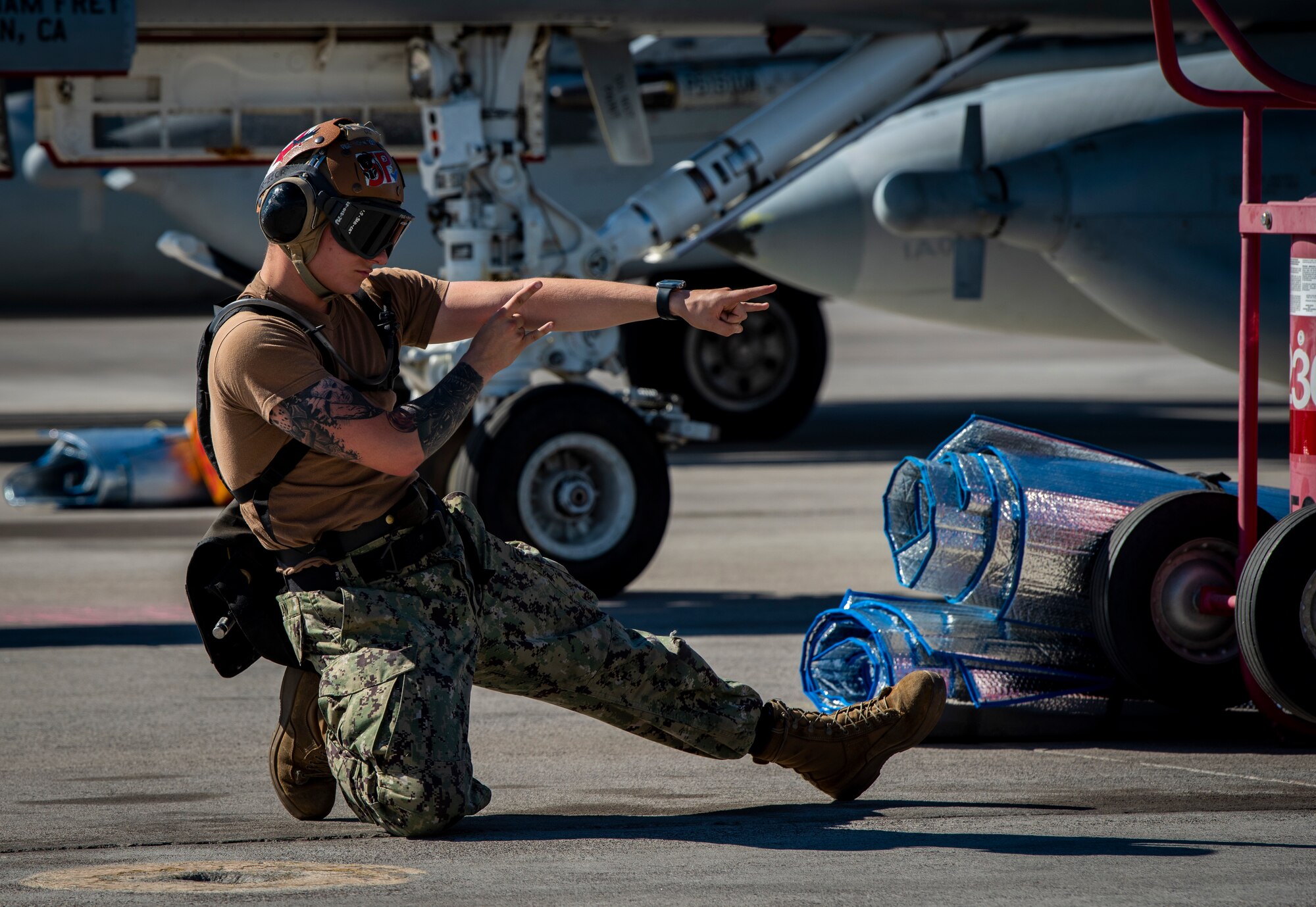 Airman signals on the flight line.