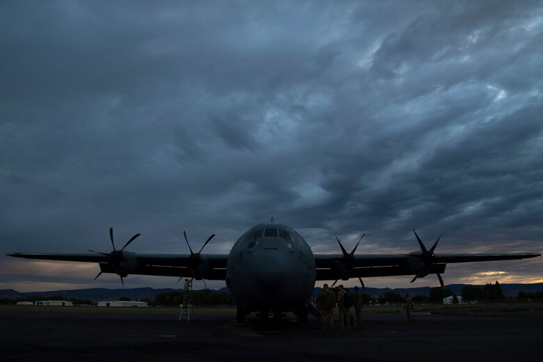 Airmen from the 19th Aircraft Maintenance Squadron finish up maintenance as pilots from the 41st Airlift Squadron prepare to board a C-130J Super Hercules during pre-deployment training at Montrose Regional Airport, Colorado, July 27, 2020. The 4/12 deployment initiative, which was developed in 2019 between airlift squadrons from Dyess AFB, Texas and Little Rock AFB, allowing each squadron a full year of dwell time followed by a four-month rotation to their respective area of responsibility. (U.S. Air Force photo by Airman 1st Class Aaron Irvin)