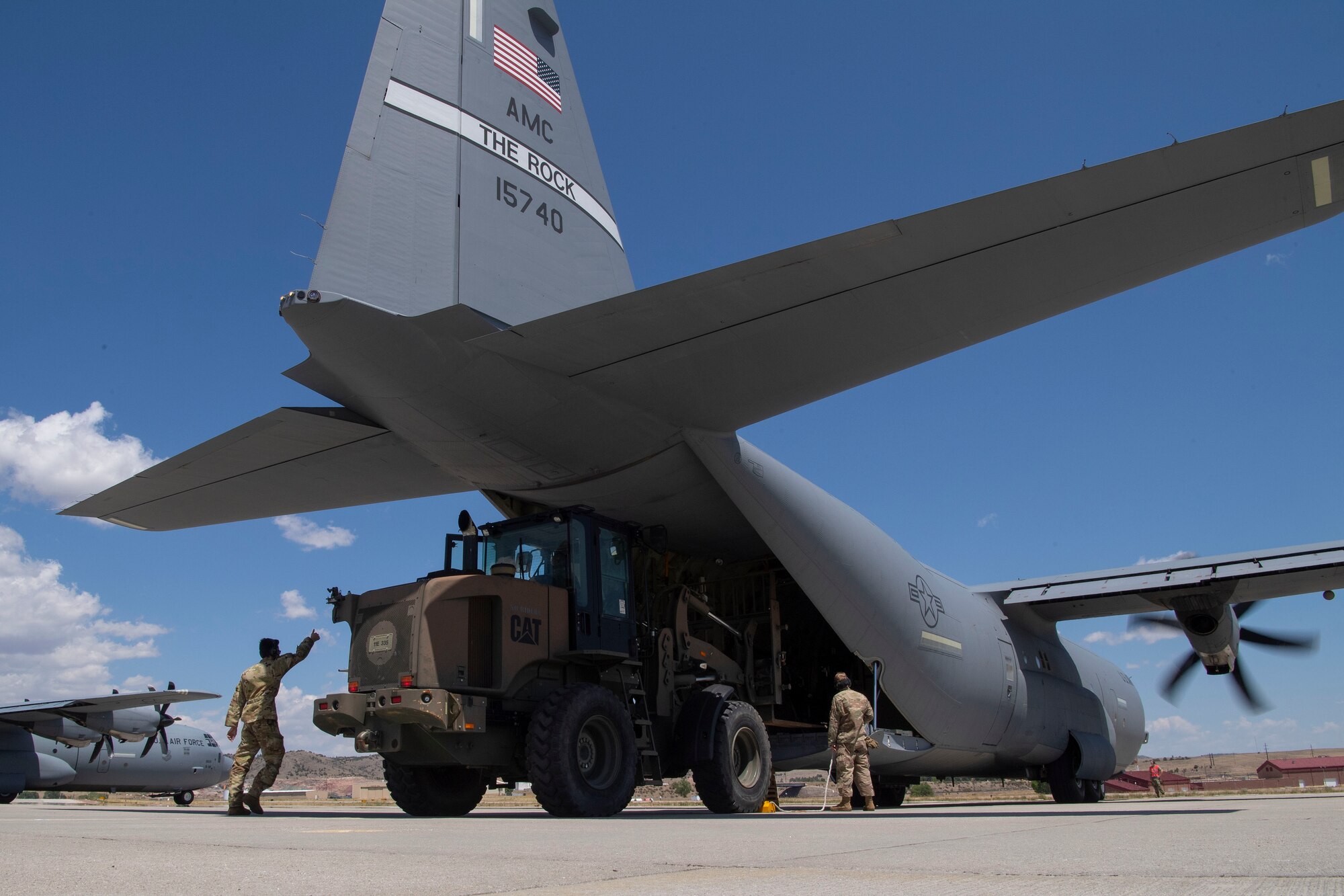 Airmen assigned to the 821st Contingency Response Squadron load cargo onto a C-130J Super Hercules during pre-deployment training at Guernsey Airport, Wyoming, July 27, 2020. This training is part of the 4/12 deployment initiative, which was developed in 2019 between airlift squadrons from Dyess Air Force Base, Texas and Little Rock AFB, allowing each squadron a full year of dwell time followed by a four-month rotation to their respective area of responsibility. (U.S. Air Force photo by Airman 1st Class Aaron Irvin)