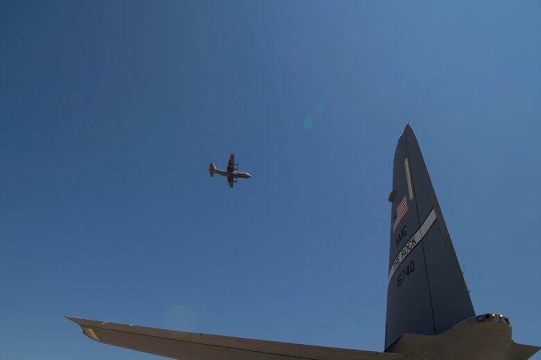 A C-130J Super Hercules assigned to the 41st Airlift Squadron flies above the flightline during pre-deployment training at Guernsey Airport, Wyoming, July 27, 2020. This training is part of the 4/12 deployment initiative, which was developed in 2019 between airlift squadrons from Dyess Air Force Base, Texas and Little Rock AFB, allowing each squadron a full year of dwell time followed by a four-month rotation to their respective area of responsibility. (U.S. Air Force photo by Airman 1st Class Aaron Irvin)