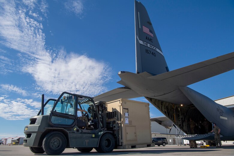 Airmen assigned to the 821st Contingency Response Squadron load cargo onto a C-130J Super Hercules during pre-deployment training at Guernsey Airport, Wyoming, July 27, 2020. This training is part of the 4/12 deployment initiative, which was developed in 2019 between airlift squadrons from Dyess Air Force Base, Texas and Little Rock AFB, allowing each squadron a full year of dwell time followed by a four-month rotation to their respective area of responsibility. (U.S. Air Force photo by Airman 1st Class Aaron Irvin)
