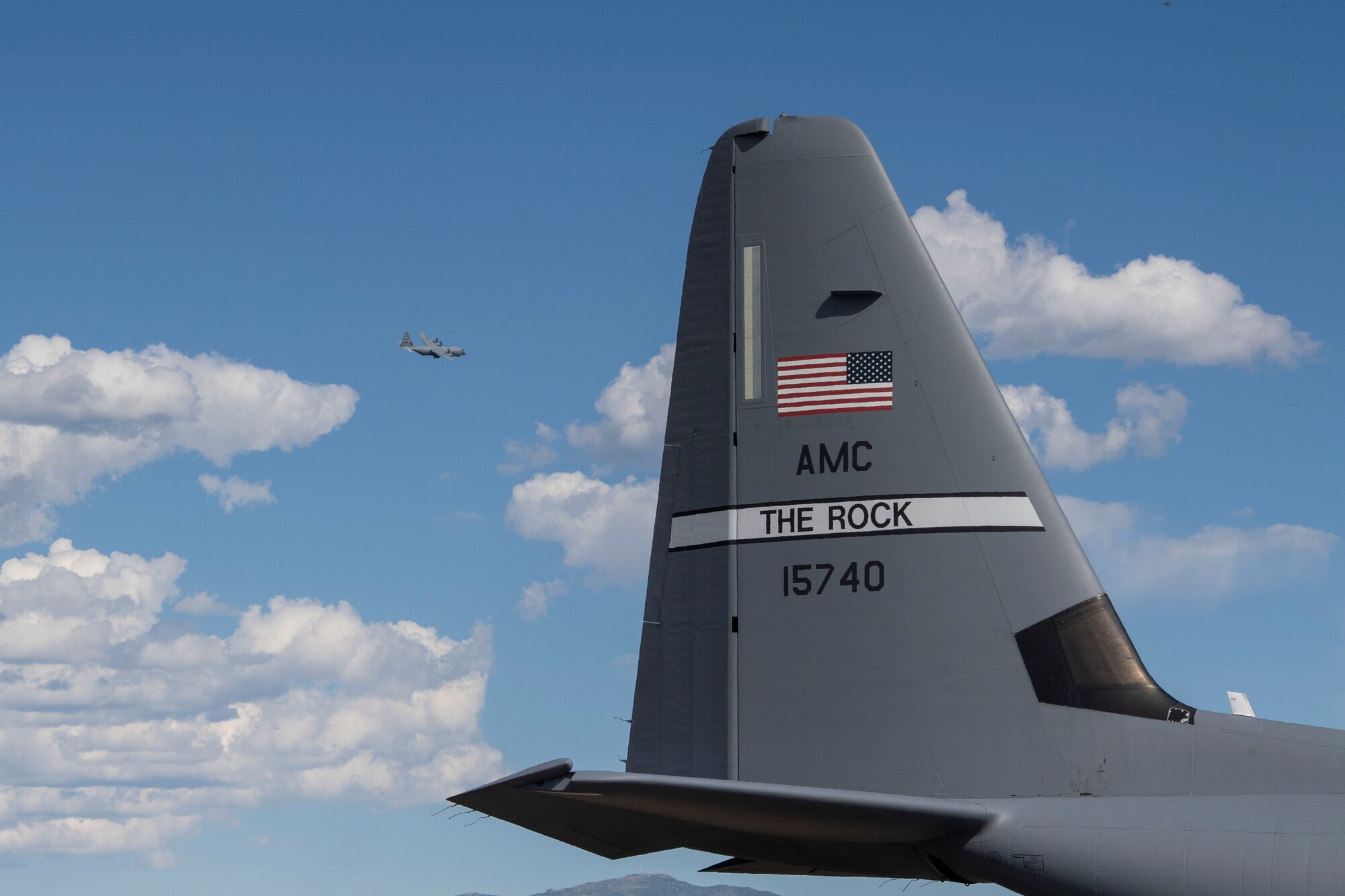 A C-130J Super Hercules assigned to the 41st Airlift Squadron flies above the flightline during pre-deployment training at Montrose Regional Airport, Colorado, July 29, 2020. This training environment helped the 41st AS familiarize the crews to mountainous terrain and high pressure altitudes similar to what they will encounter in their area of responsibility overseas. (U.S. Air Force photo by Airman 1st Class Aaron Irvin)
