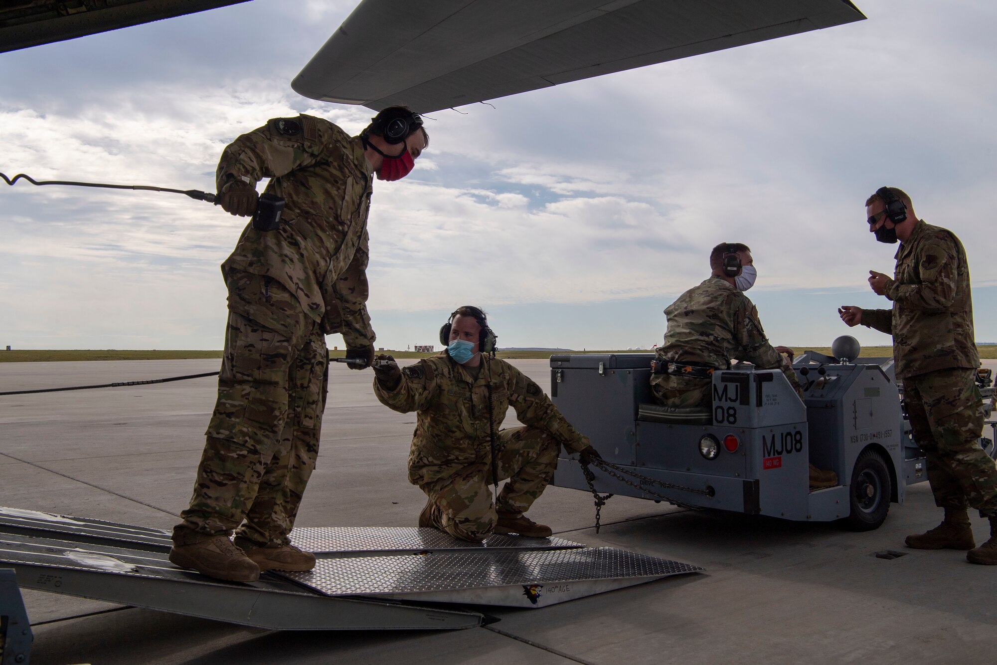 Members from the 41st Airlift Squadron and the 140th Wing, Colorado Air National Guard load cargo onto a C-130J Super Hercules during pre-deployment training at Buckley Air Force Base, Colorado, July 27, 2020. The 4/12 deployment initiative, which was developed in 2019 between airlift squadrons from Dyess AFB, Texas and Little Rock AFB, allowing each squadron a full year of dwell time followed by a four-month rotation to their respective area of responsibility. (U.S. Air Force photo by Airman 1st Class Aaron Irvin)