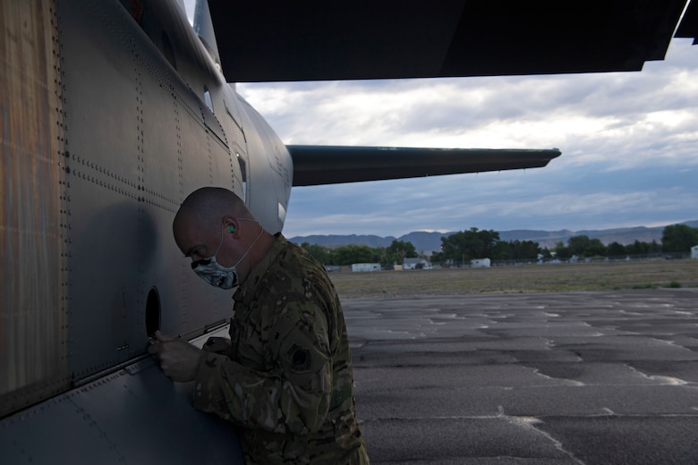 Capt. Matthew Calland, 41st Airlift Squadron chief of tactics, inspects his C-130J Super Hercules prior to flight during pre-deployment training at Montrose Regional Airport, Colo., July 28, 2020. Throughout the training, the 41st AS was able to perform airdrops, offload cargo, fly low-levels, land on dirt runways, integrate with other wings, operate in low-light environments and navigate topography that the squadron is unable to replicate at home station.