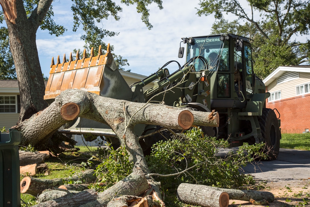 U.S. Marine Corps Lance Cpl. Anderson Rojas, with 8th Engineer Support Battalion, 2nd Marine Logistics Group, clears debris at Berkley Manor on Marine Corps Base Camp Lejeune, North Carolina, Aug. 4, 2020. U.S. Marines carried out recovery efforts after Hurricane Isaias in order to resume normal operations while following COVID-19 mitigation guidelines. (U.S. Marine Corps Photo by Lance Cpl. Isaiah Gomez)