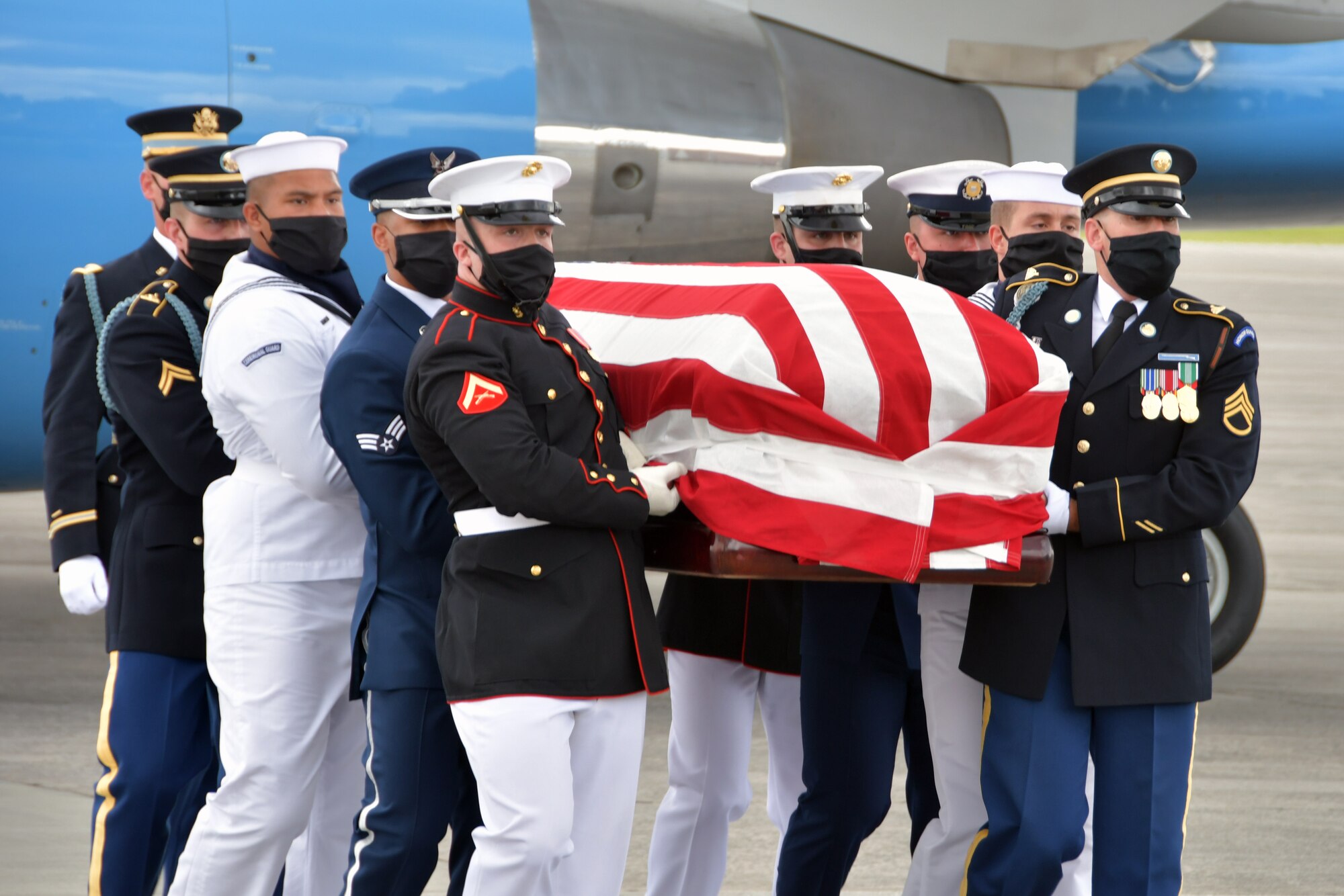 An Armed Forces Body Bearer Team carries the flag-draped casket of Rep. John Lewis at Dobbins Air Reserve Base, Georgia, July 29, 2020. DoD personnel are honoring the congressman by providing military funeral honors during his congressional funeral events. (U.S. Air Force photo by Airman 1st Class Kendra A.  Ransum)