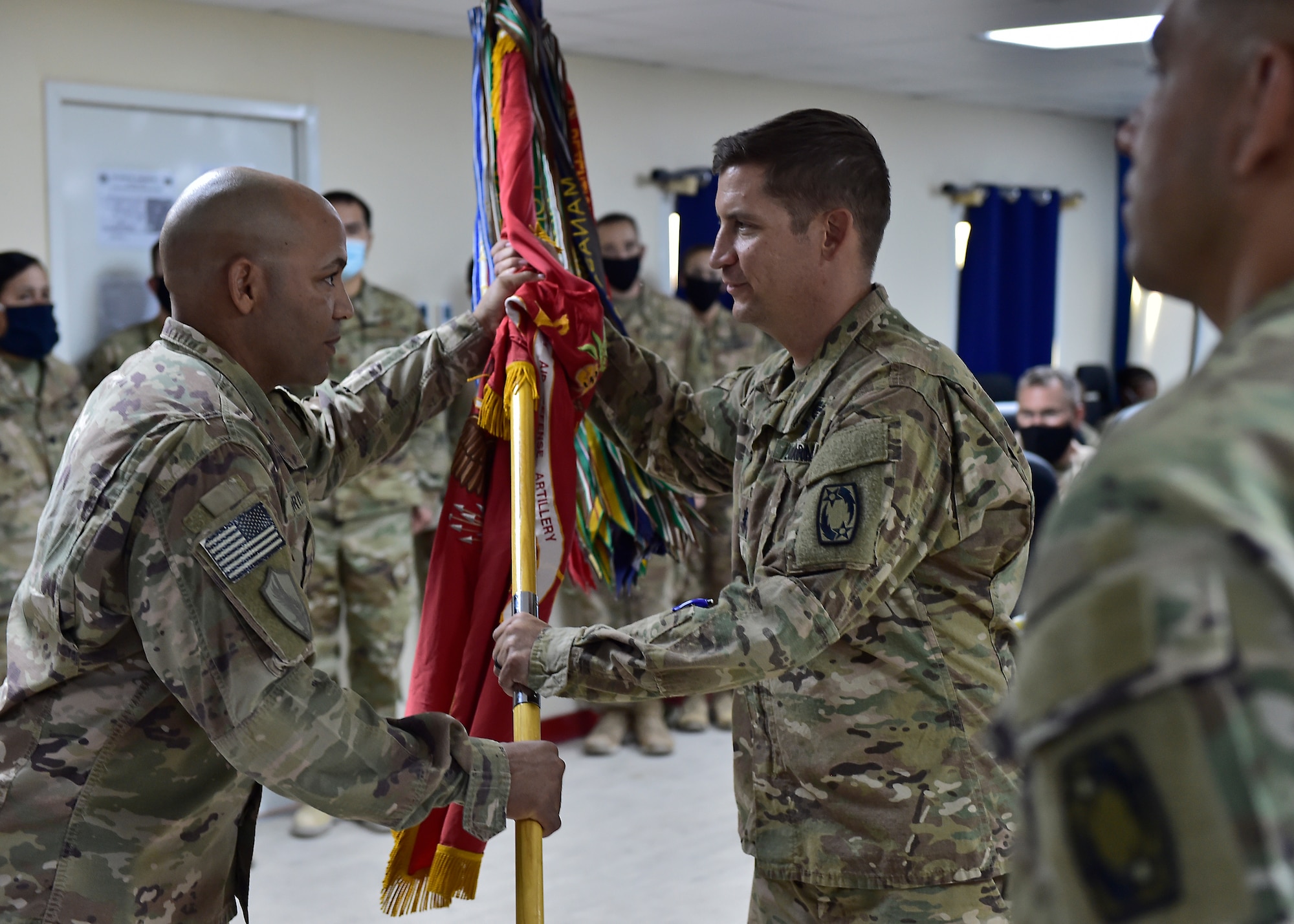 U.S. Army CSM Seagram Porter, outgoing command sergeant major, relinquishes responsibility of the 4-5 Air Defense Artillery Regiment to CSM Tomas Barrios during a Change of Responsibility Ceremony at Prince Sultan Air Base, Kingdom of Saudi Arabia.