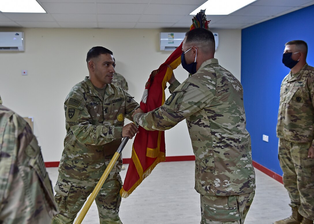 U.S. Army CSM Seagram Porter, outgoing command sergeant major, relinquishes responsibility of the 4-5 Air Defense Artillery Regiment to CSM Tomas Barrios during a Change of Responsibility Ceremony at Prince Sultan Air Base, Kingdom of Saudi Arabia.