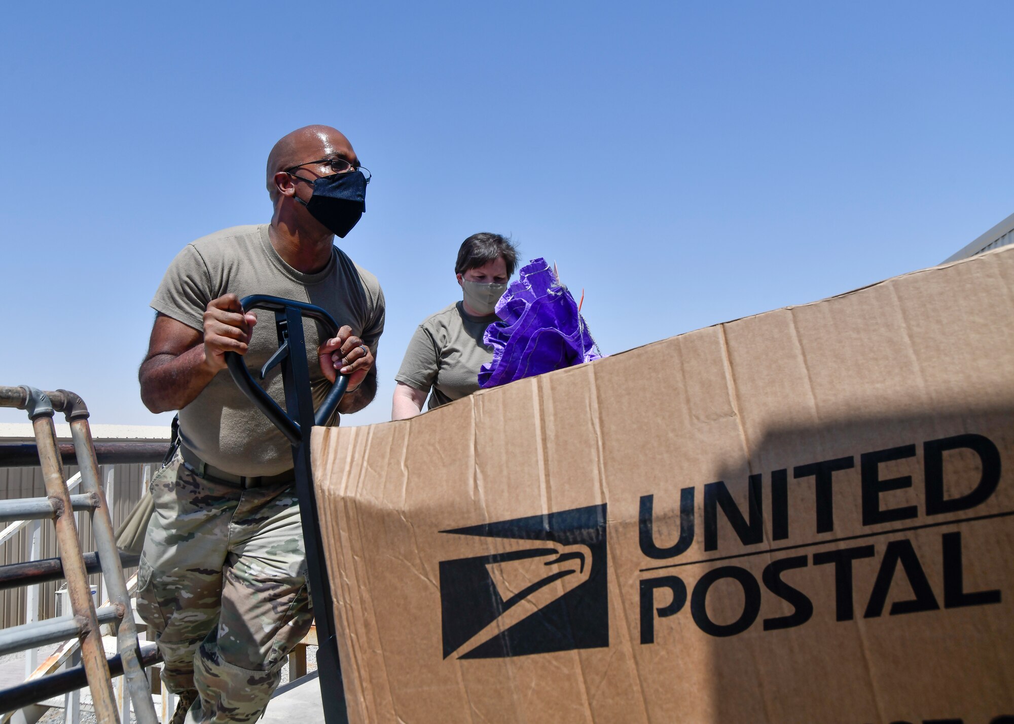 Airmen unload mail from truck