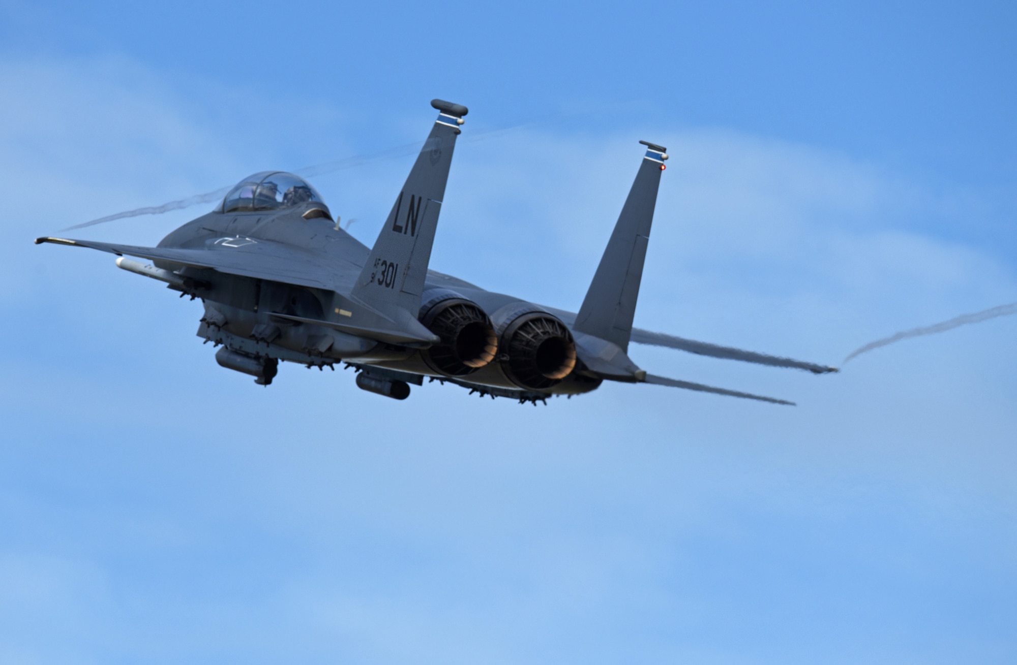 An F-15E Strike Eagle, assigned to the 492nd Fighter Squadron, flies over Royal Air Force Lakenheath, England, Aug. 4, 2020. The Liberty Wing F-15s provide worldwide responsive combat airpower and support through its highly capable maneuverability and acceleration, weapons systems and avionics. (U.S. Air Force photo by Airman 1st Class Rhonda Smith)