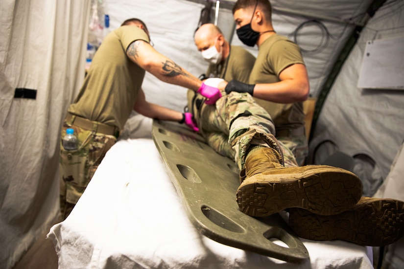 Medics examine a patient for a gunshot exit wound during a mass casualty training event at Collective Training Center-Yavoriv, Ukraine on July 27.