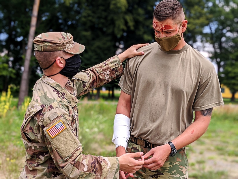 Spc. Neville of the 33rd IBCT tends to wounds on Sgt. Lefebvre of the 32nd IBCT during a mass casualty event at Collective Training Center-Yavoriv, Ukraine July 27.