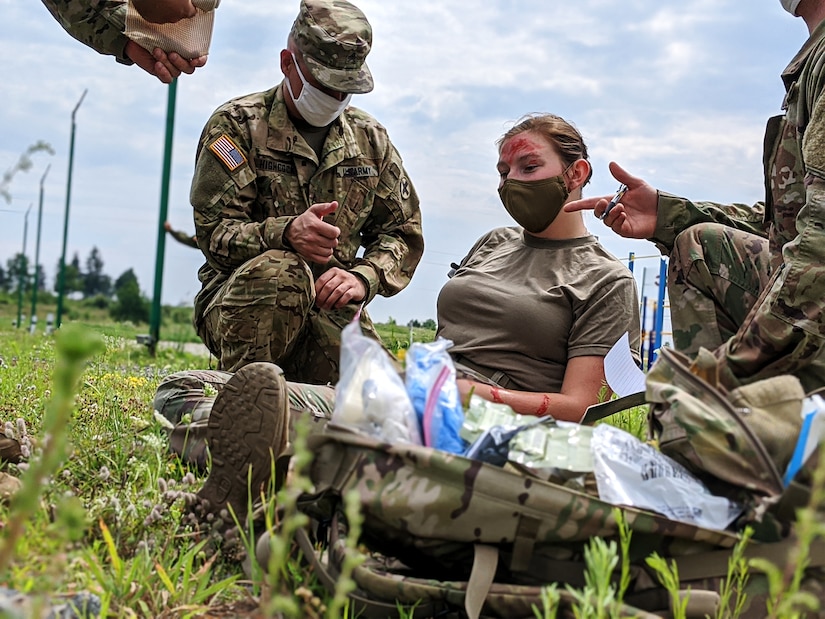Sgt. Braden Highcock of Task Force Illini, 33rd Infantry Brigade Combat Team, Illinois National Guard assesses Sgt. Alicia Sobczak of Task Force Juvigny as a casualty during mass casualty event at Collective Training Center- Yavoriv, Ukraine, July 27.