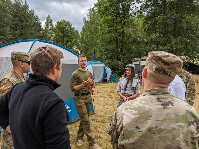 Radoslaw Kalamarz, chief of Camp Watra and 10 year veteran of the Polish Scouting and Guiding Association, speaks with U.S. Soldiers about the history and values of the scouting organization during an engagement near Osieczow, Poland, July 17, 2020.