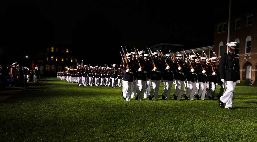 Marines with Marine Barracks Washington, D.C. march across the parade deck for “pass in review” during a Friday Evening Parade at the Barracks, July 31, 2020. The Honorable Mr. James F. Geurts, Assistant Secretary of the Navy for Research, Development & Acquisition (ASN (RD&A)), was the guest of honor, and the Assistant Commandant of the Marine Corps, Gen. Gary L. Thomas, was the hosting official for the evening. To effectively host Evening Parades, the Barracks follows Department of Defense guidelines and Centers for Disease Control and Prevention (CDC) recommendations. Additionally, we apply several of Washington D.C.’s safeguards to include: physical distancing for patrons, health screenings, and mandatory wear of protective equipment.