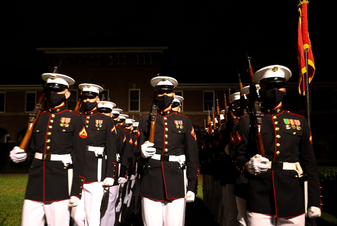 Marines with Marine Barracks Washington, D.C. march off the parade deck for “pass in review” during a Friday Evening Parade at the Barracks, July 31, 2020. The Honorable Mr. James F. Geurts, Assistant Secretary of the Navy for Research, Development & Acquisition (ASN (RD&A)), was the guest of honor, and the Assistant Commandant of the Marine Corps, Gen. Gary L. Thomas, was the hosting official for the evening. To effectively host Evening Parades, the Barracks follows Department of Defense guidelines and Centers for Disease Control and Prevention (CDC) recommendations. Additionally, we apply several of Washington D.C.’s safeguards to include: physical distancing for patrons, health screenings, and mandatory wear of protective equipment.