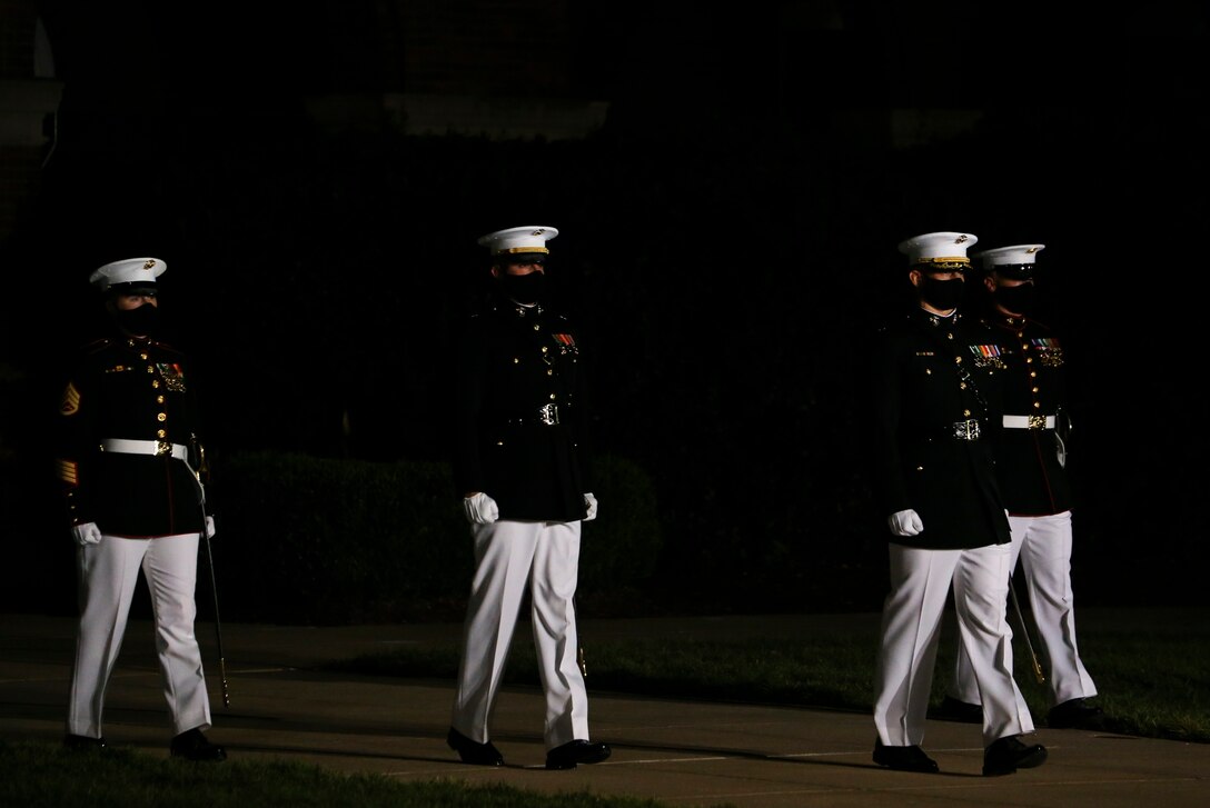 The Marine Barracks Washington D.C. parade marching staff march down “Center Walk” during a Friday Evening Parade at the Barracks, July 31, 2020. The Honorable Mr. James F. Geurts, Assistant Secretary of the Navy for Research, Development & Acquisition (ASN (RD&A)), was the guest of honor, and the Assistant Commandant of the Marine Corps, Gen. Gary L. Thomas, was the hosting official for the evening. To effectively host Evening Parades, the Barracks follows Department of Defense guidelines and Centers for Disease Control and Prevention (CDC) recommendations. Additionally, we apply several of Washington D.C.’s safeguards to include: physical distancing for patrons, health screenings, and mandatory wear of protective equipment.
